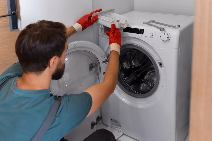 Technician repairing a washing machine